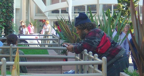 homeless guy on a cell phone